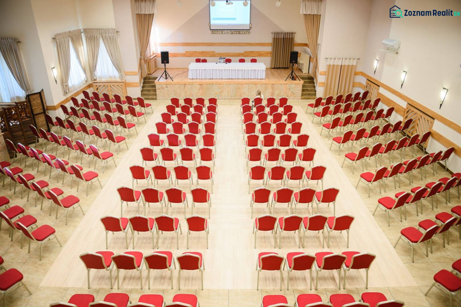 Konferenzraum mit roten Stühlen und Holzboden in Hotels und Pensionen.