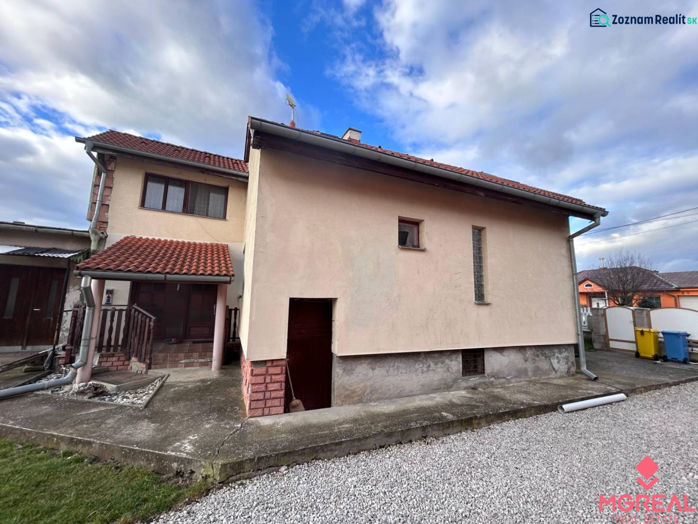 Ein Einfamilienhaus in Zbehy mit einem Schrägdach und einem Gehweg neben der Garage.