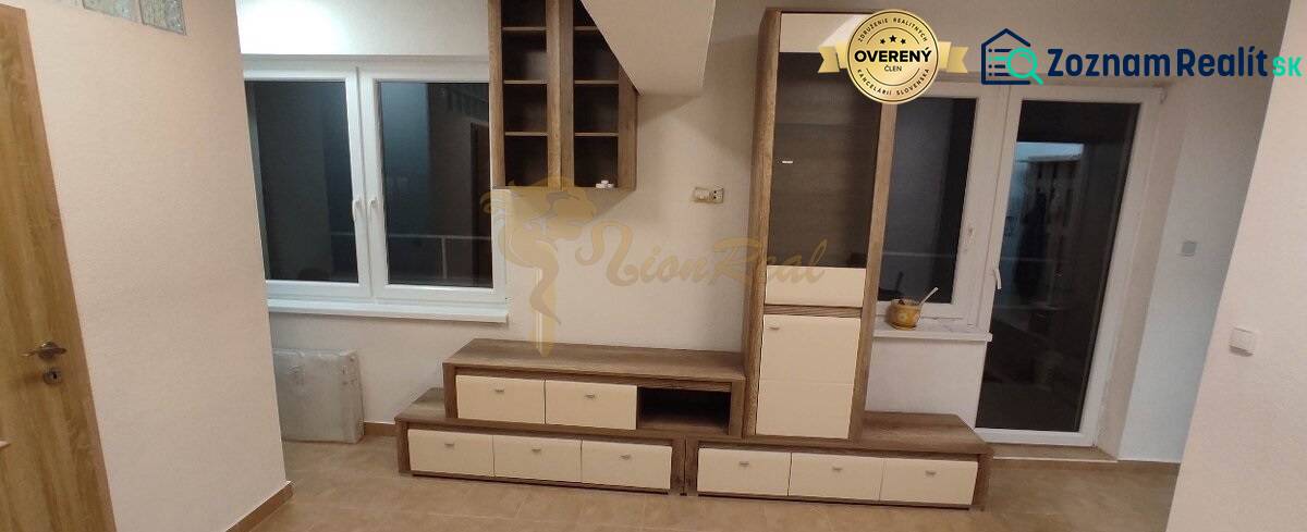 Wohnzimmer in einer Einzimmerwohnung mit Möbeln, Fenster und Boden in Holzoptik.