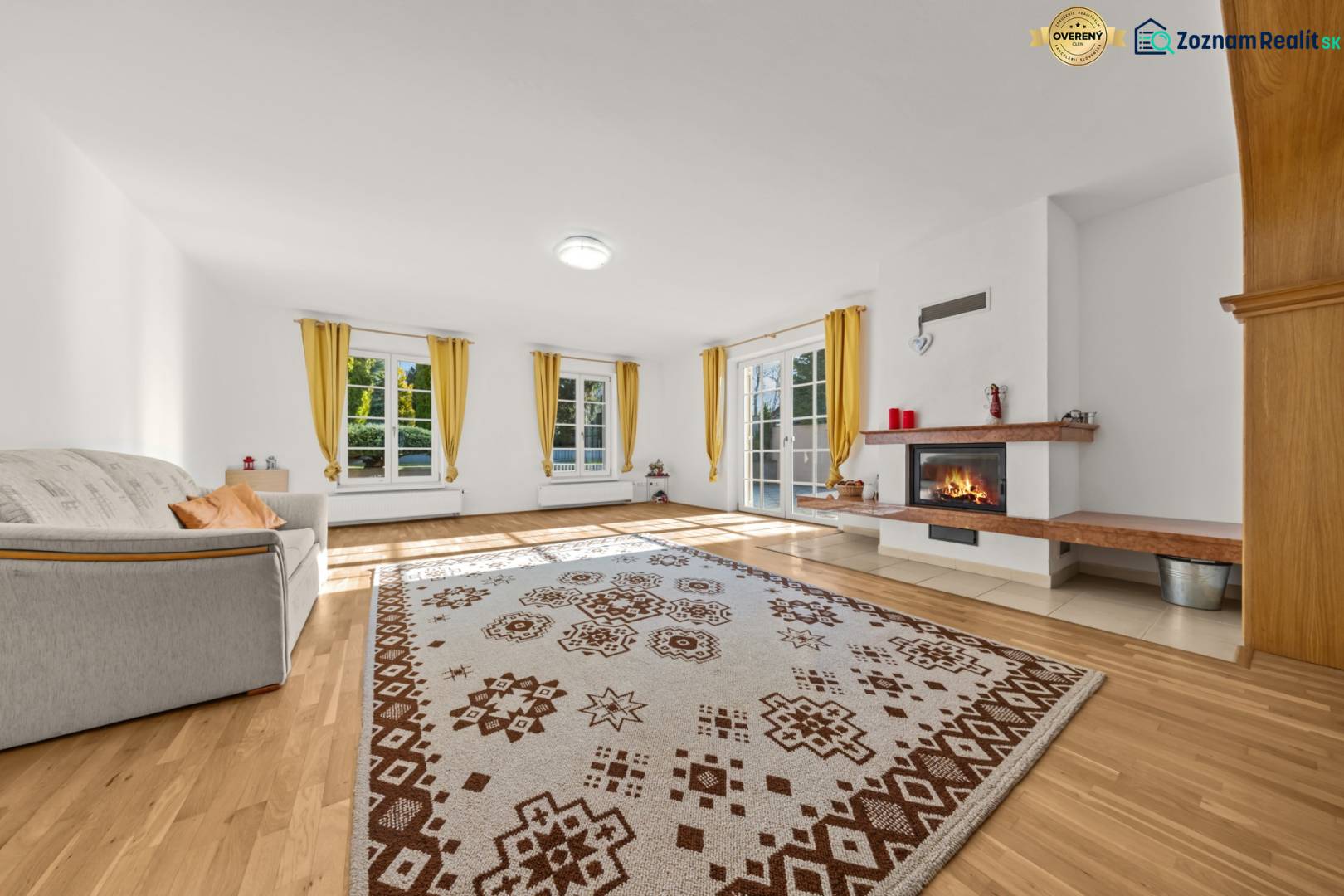 Wohnzimmer mit Kamin, Sofa und Holzboden in einem Einfamilienhaus.