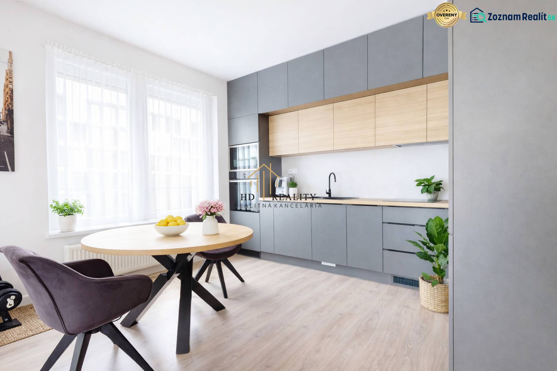 Küche in einer 3-Zimmer-Wohnung mit modernen Möbeln und einem Boden in Holzoptik.