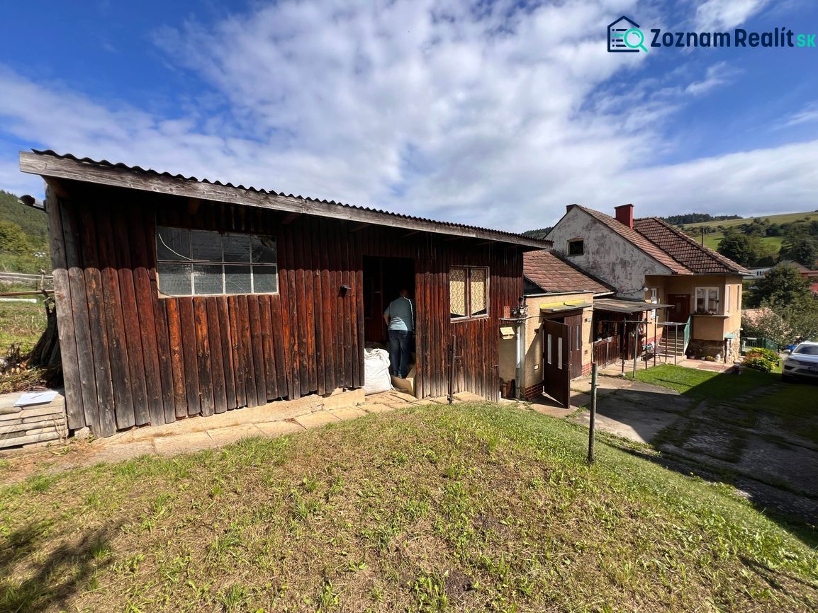 Der Hof des Einfamilienhauses in Kalameny mit Garten und Himmel mit Wolken.