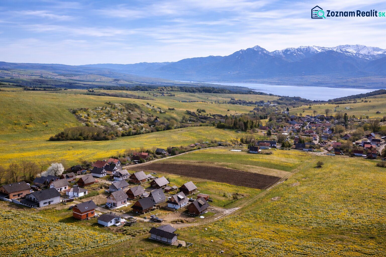 Ländliche Landschaft in Ižipovce mit Einfamilienhäusern und Blick auf die Bergszenerie.