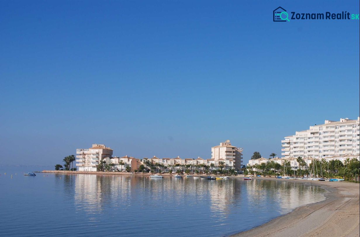 Die Küste mit Ferienwohnungen in La Manga del Mar Menor am ruhigen Meer und blauem Himmel.