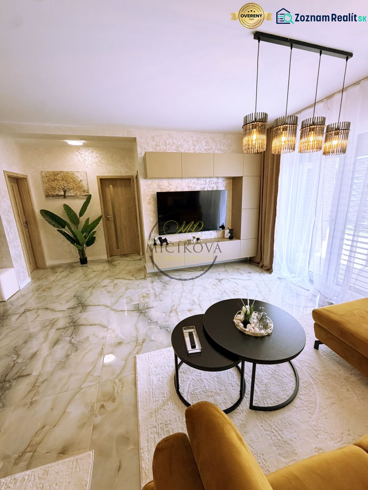 Wohnzimmer in einer Zweizimmerwohnung mit Marmorboden und stilvoller Beleuchtung.