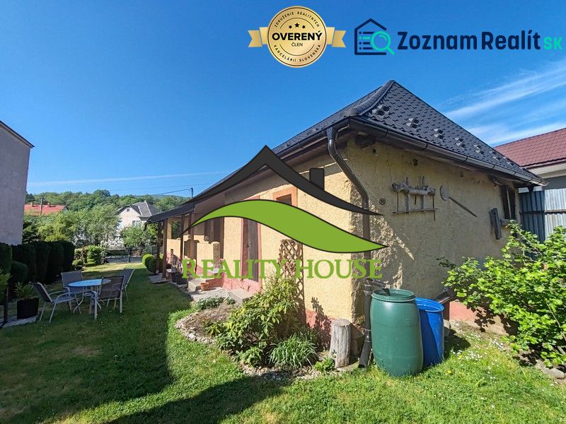 Das Einfamilienhaus in der Hauptstraße in Banské mit einem schönen Hof, Gartenmöbeln und Vegetation.