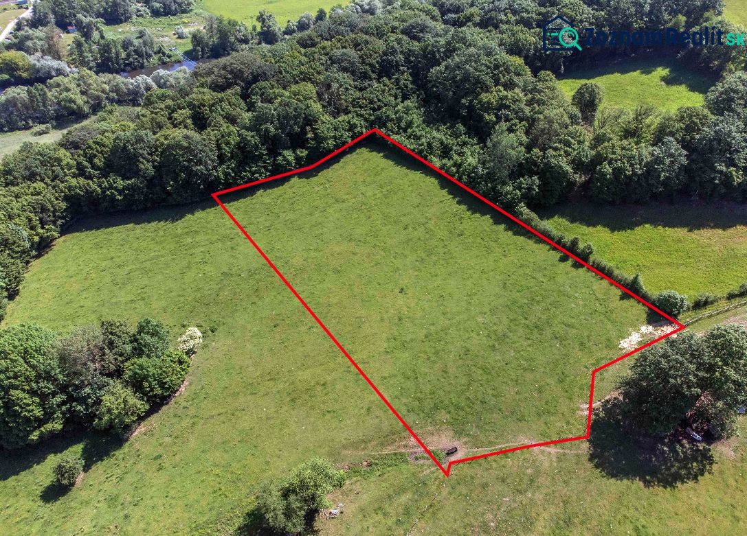 Luftaufnahme von Erholungsgrundstücken in Ostrá Lúka mit Wald im Hintergrund.