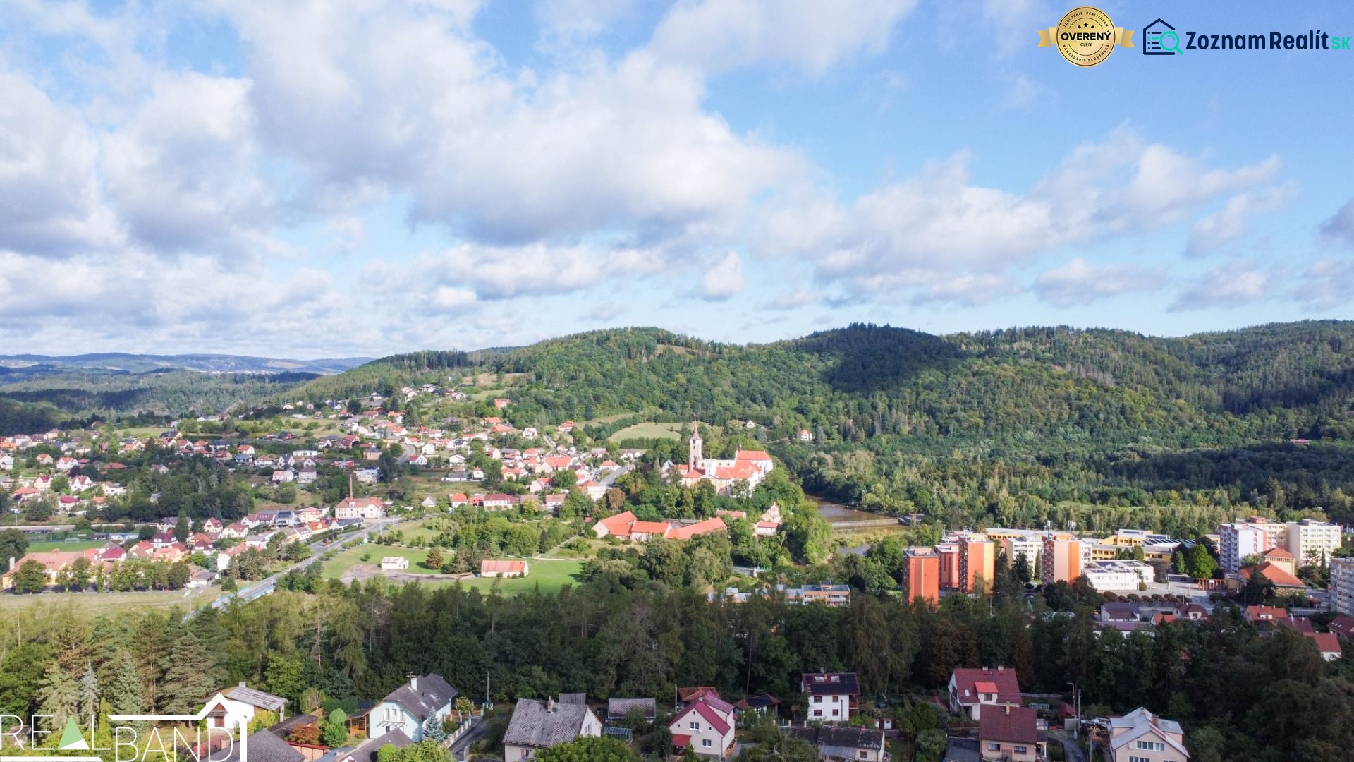 Blick auf die Stadt Sázava von der Straße Na Vrších, umgeben von Grün und Einfamilienhäusern.