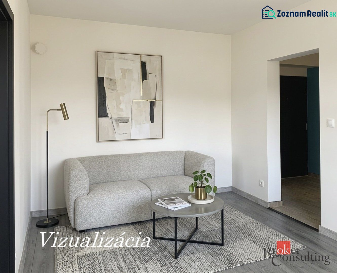 Ein Zimmer in einer Einzimmerwohnung mit einem Sofa, einem Bild und einem Boden in Holzoptik.