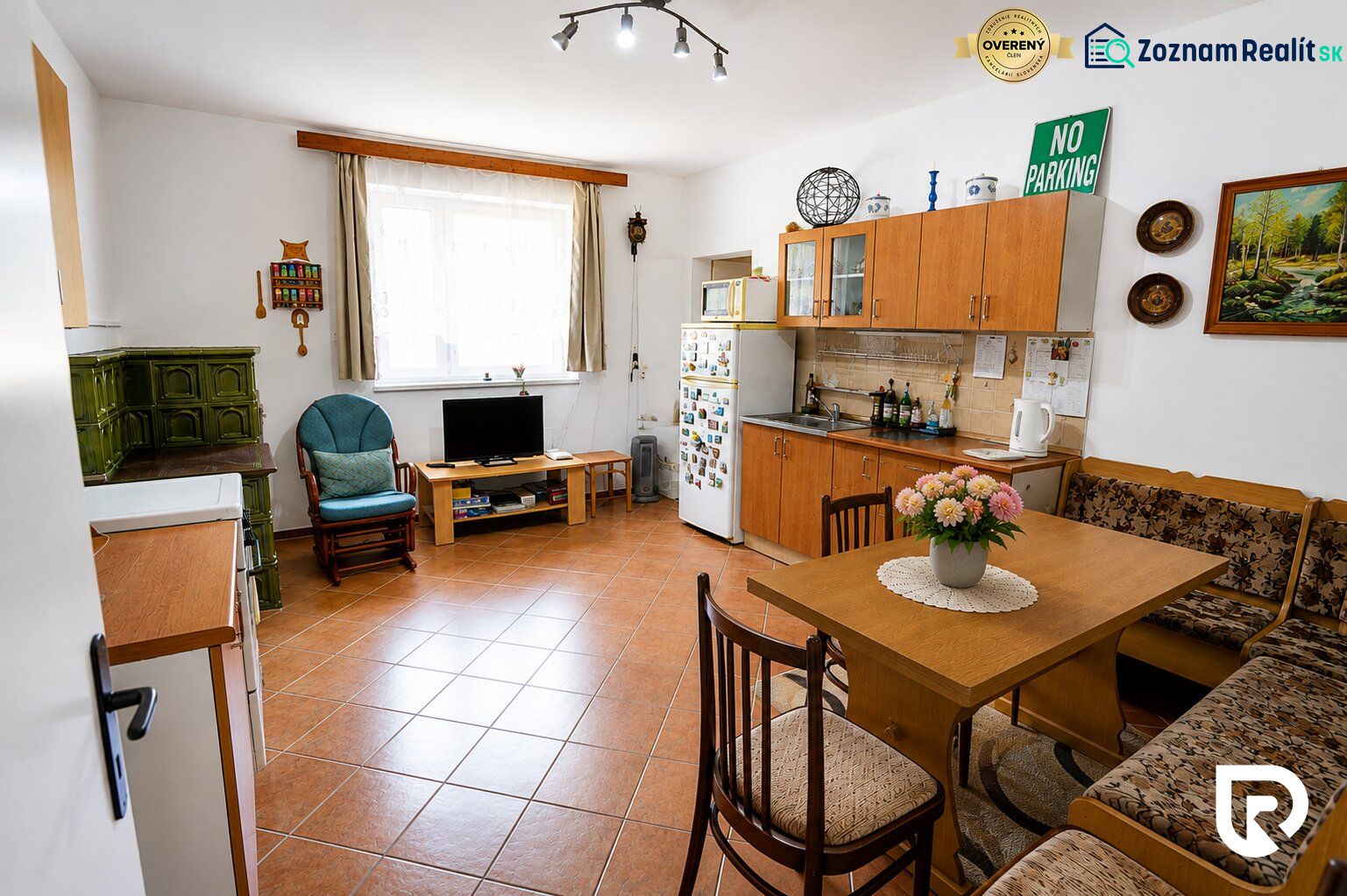 Küche in einem Einfamilienhaus mit Kamin, Möbeln und Dekorationen, Boden mit Holzdekor.