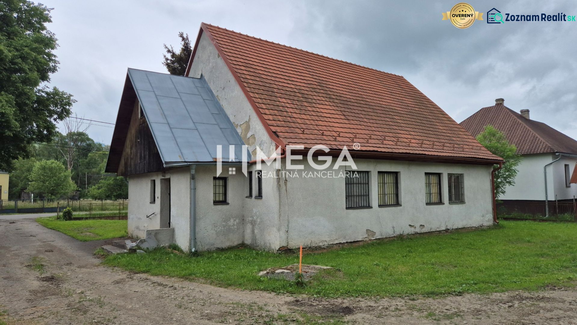 Ein Gebäude mit rotem Dach in Zboj, umgeben von Grünflächen und Nachbarhäusern, nutzbar als Geschäftsräume.