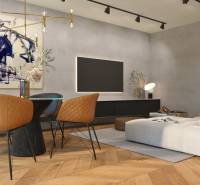 Wohnzimmer in einer Zweizimmerwohnung mit einem bequemen Sessel und künstlerischer Dekoration.