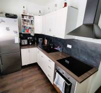 Küche in einer 2-Zimmer-Wohnung, ausgestattet mit Geräten und Stauraum.