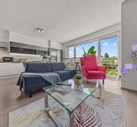 Wohnzimmer mit Sofa und Sessel in einer 4-Zimmer-Wohnung. Große Fenster mit Aussicht.