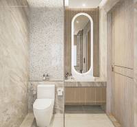 Badezimmer in einer 3-Zimmer-Wohnung mit moderner Sanitärausstattung und beleuchtetem Spiegel.