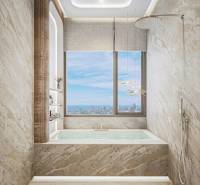 Luxuriöses Badezimmer mit Badewanne, großem Fenster und Aussicht aus einer Drei-Zimmer-Wohnung.