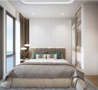 Helles Schlafzimmer mit großem Fenster und Meerblick in einer 3-Zimmer-Wohnung.