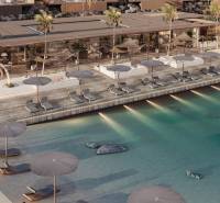 Luxuriöser Pool und Strandliegen vor einem Einfamilienhaus an der Küste.