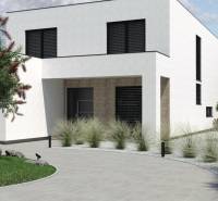 Ein Einfamilienhaus in Opoj mit einem minimalistischen Garten und einem gepflegten Eingang.