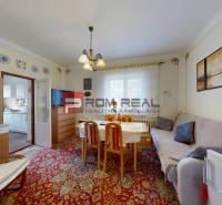Wohnzimmer in einem Einfamilienhaus mit Sofa, Esstisch und Wanddekorationen.
