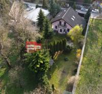 Ein Einfamilienhaus in Píla, umgeben von Bäumen, mit einem gepflegten Garten und benachbarten Gebäuden.