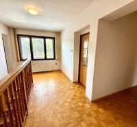 Ein Flur mit Parkettboden und Glastüren in einem Einfamilienhaus.