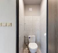 Badezimmer mit WC, gefliest mit hellen Fliesen, in einer 3-Zimmer-Wohnung.