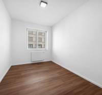 Ein leerer Raum mit Holzboden und einem Fenster in einer 3-Zimmer-Wohnung.