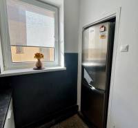 Küche einer 3-Zimmer-Wohnung mit Kühlschrank und Fenster mit Jalousie.
