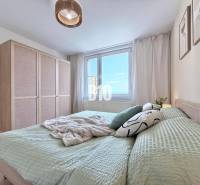 Helles Schlafzimmer in einer 3-Zimmer-Wohnung mit großem Bett, Kleiderschrank und Fenster.