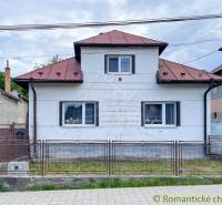Ein Einfamilienhaus in Sielnica mit einem Blechdach und einem Metallzaun.
