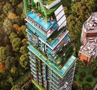Wohnungsbau in Pattaya mit grünen Terrassen, eingebettet zwischen Bäumen und Bebauung.