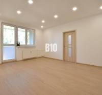 Wohnzimmer mit Parkettboden und weißen Wänden in einer 3-Zimmer-Wohnung.