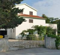 Ein Einfamilienhaus in Vrsi mit weißer Fassade, rotem Dach und umgebendem Grün.