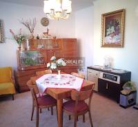 Wohnzimmer eines Einfamilienhauses mit Esstisch, Sessel und Möbeln.