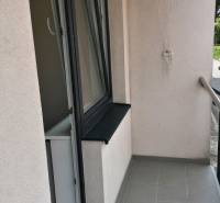 Der Balkon einer 2-Zimmer-Wohnung in der Nábrežná-Straße in Vrútky mit Fliesen und Geländer.