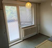 Innenraum einer Einzimmerwohnung mit Jalousien am Fenster und Hängelampe.