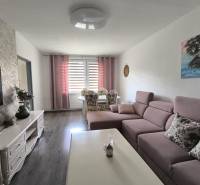 Wohnzimmer in einer 3-Zimmer-Wohnung mit Sofa, Esstisch und Fernseher.