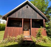 Ein Holzfamilienhaus in Vagrinec, umgeben von Rasen und Grünflächen.