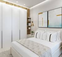 Helles Schlafzimmer in einer 3-Zimmer-Wohnung mit weißen Schränken und bunten Bildern.