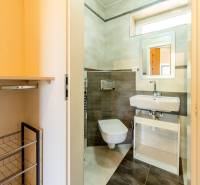 Badezimmer in einer 4-Zimmer-Wohnung mit hängendem WC, Waschbecken und Unterschrank.