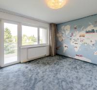 Ein Zimmer in einer 4-Zimmer-Wohnung mit einer Weltkarte an der Wand und Blick in den Garten.