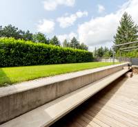 Terrasse mit Holzdekor und grünem Rasen bei einer 3-Zimmer-Wohnung in der Devínska-Straße.