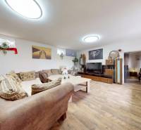 Wohnzimmer mit Sofa, Holzboden und dekorativen Bildern in einem Einfamilienhaus.