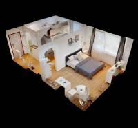 3D-Grundriss einer Einzimmerwohnung mit Bett, Küchenzeile und Tisch.