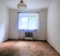 Ein Zimmer mit Holzboden und Fenster in einer 2-Zimmer-Wohnung.