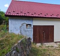Ein Einfamilienhaus in der Dlha-Straße in Vranov nad Topľou mit rotem Dach und einer Holzgarge.