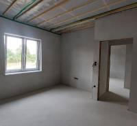 Innenraum eines Einfamilienhauses mit verputzten Wänden, Fenster mit Aussicht.