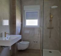 Badezimmer in einer 3-Zimmer-Wohnung mit Waschbecken, Toilette und Duschkabine.