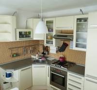 Küche in einer 3-Zimmer-Wohnung mit Küchenzeile, Geräten und orangefarbenen Fliesen.